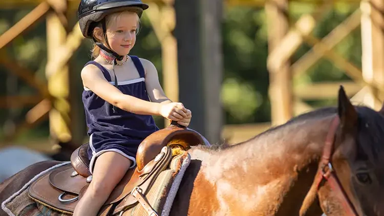 CrISTA Camps Summer Camp - Young girl riding horse
